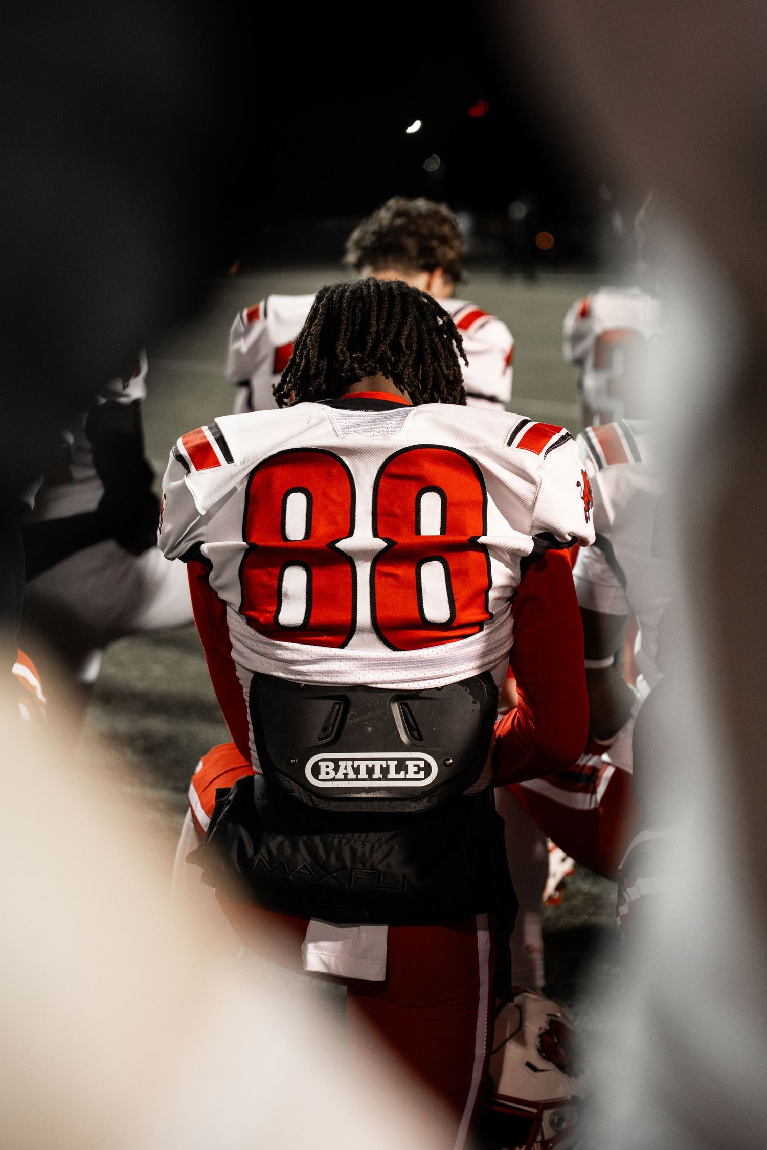 Close-up of football helmets with number 00 showing Battle brand equipment.