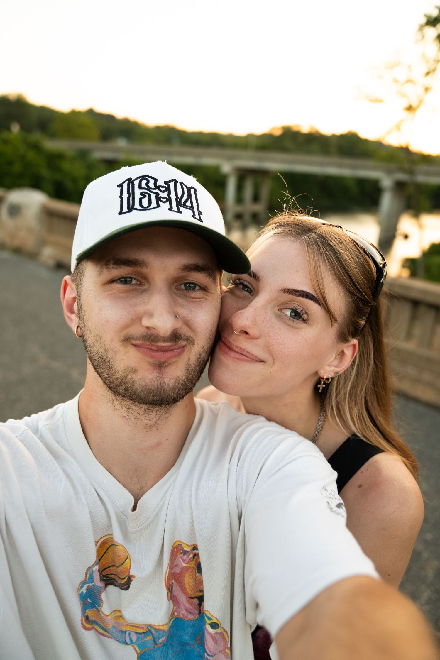 Couple shares intimate moments during sunset photoshoot outdoors.