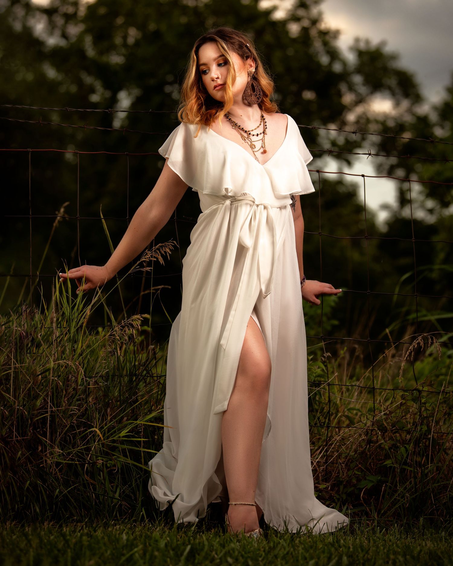 Ethereal outdoor portraits featuring flowing white dress in natural setting.