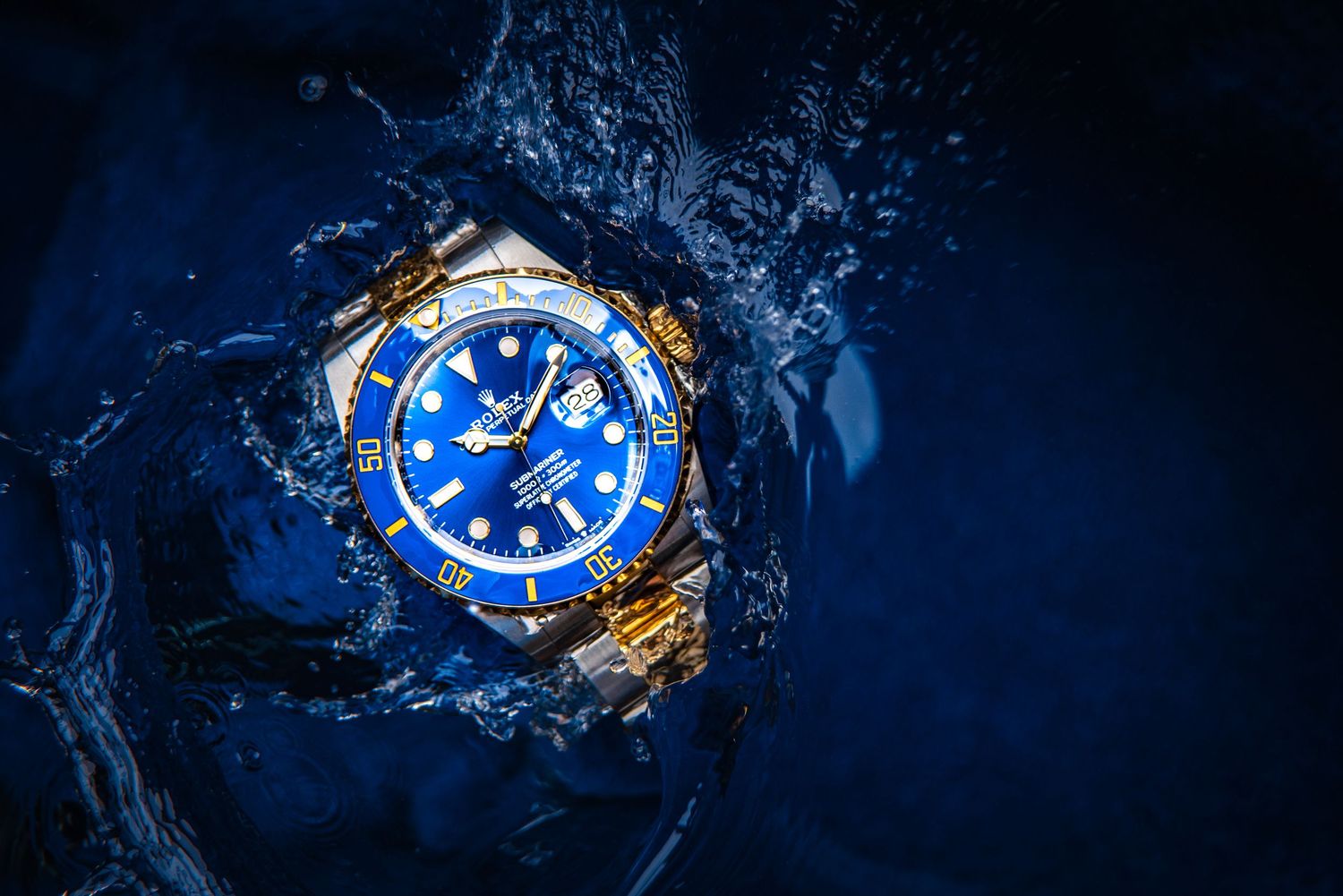 Blue luxury watches photographed underwater with dynamic lighting and reflections.