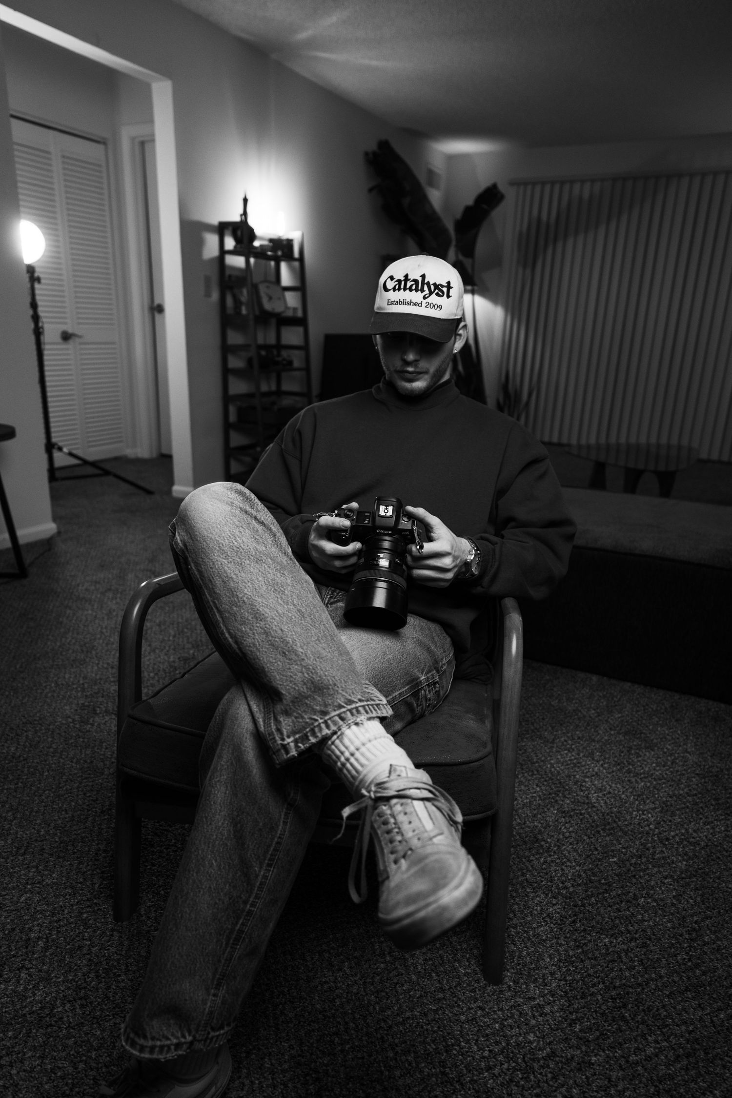 Black and white photo sequence showing someone lounging on a carpeted floor in jeans while holding a drink.