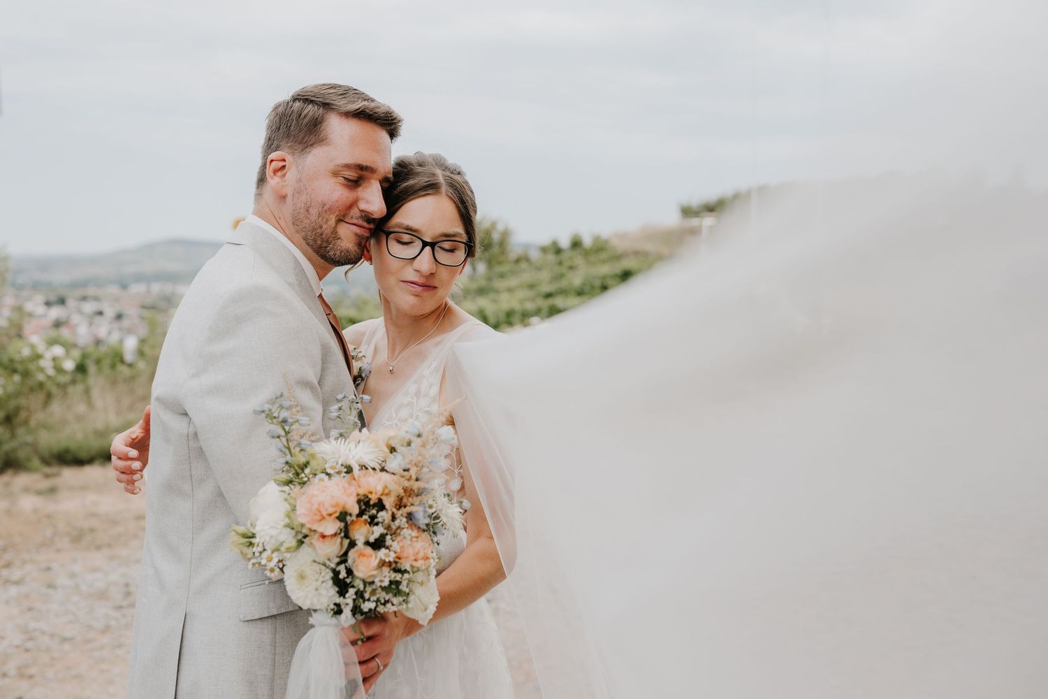 Joyful celebration moment outside a grand European-style mansion with cypress trees.