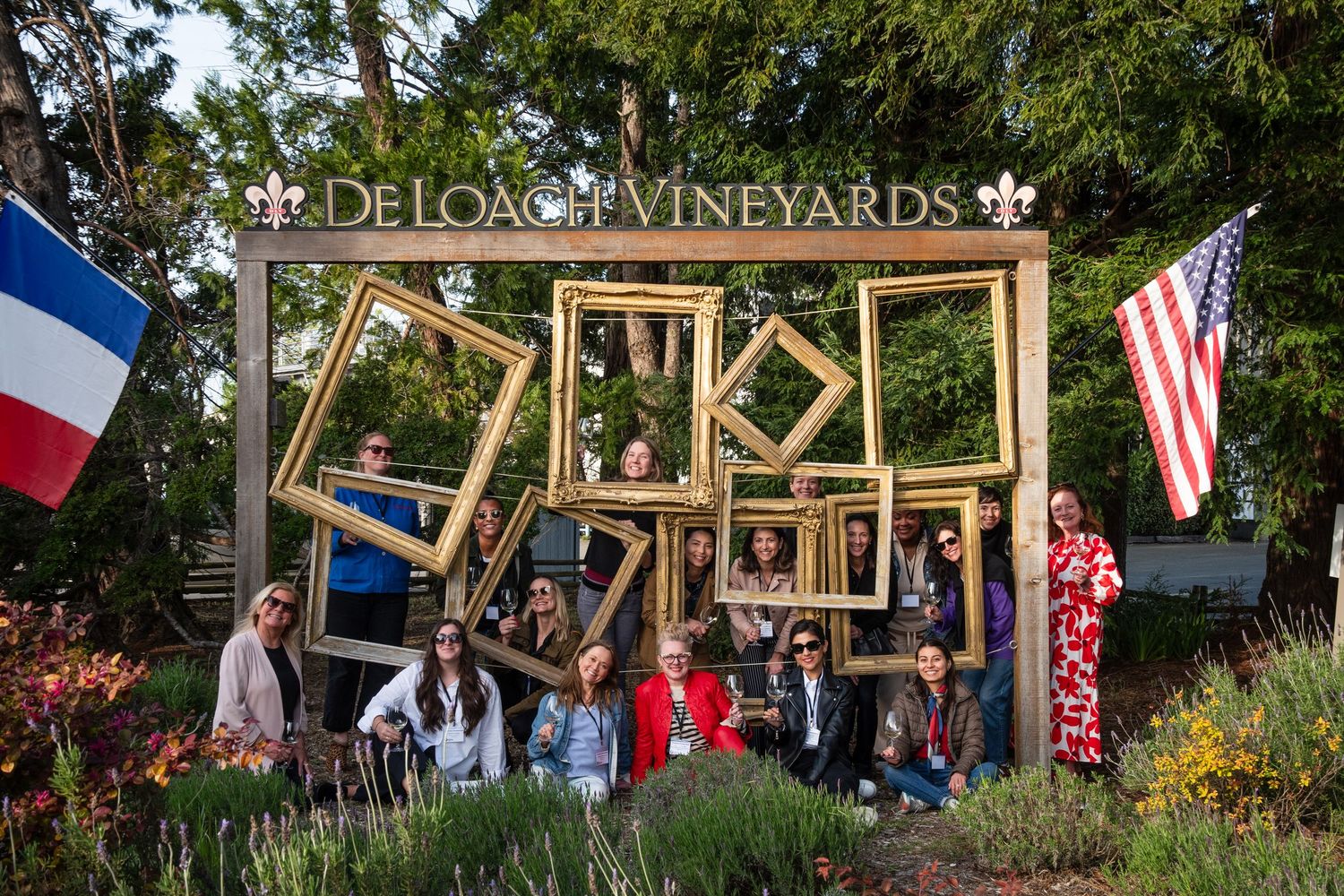 Outdoor photo installation with wooden frames at DeLosa Vineyards featuring American and French flags.