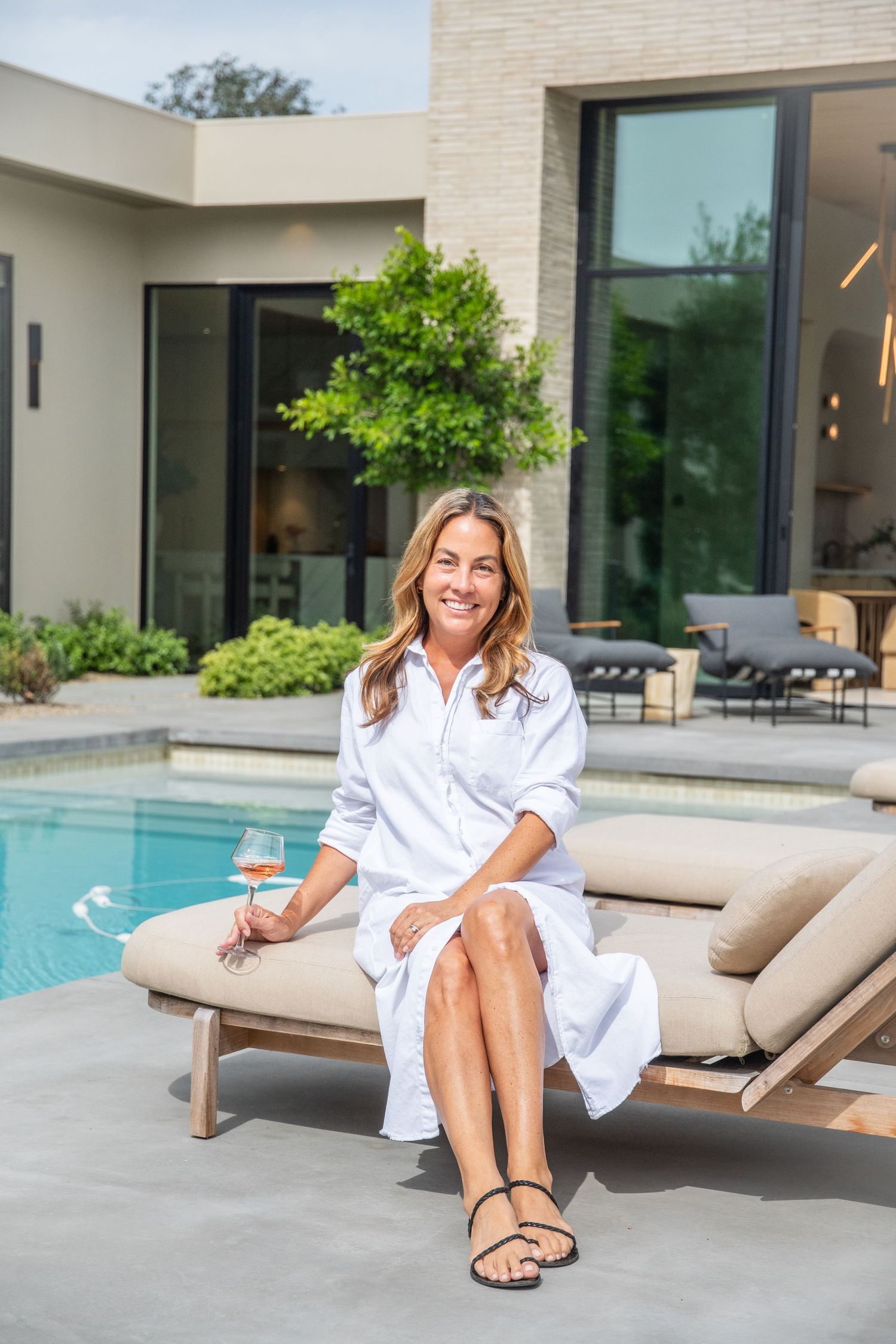 Luxurious poolside setting with modern lounge furniture and contemporary architecture.