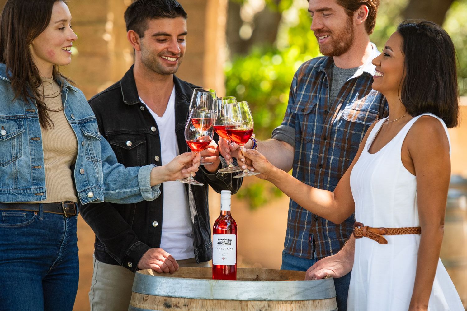 Group enjoying wine and conversation at an outdoor gathering.