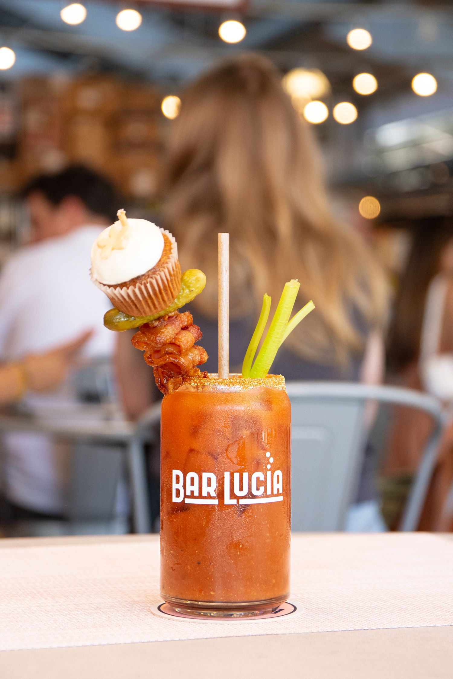 Spicy Bloody Mary cocktail garnished with celery and olives at Bar Lucia.