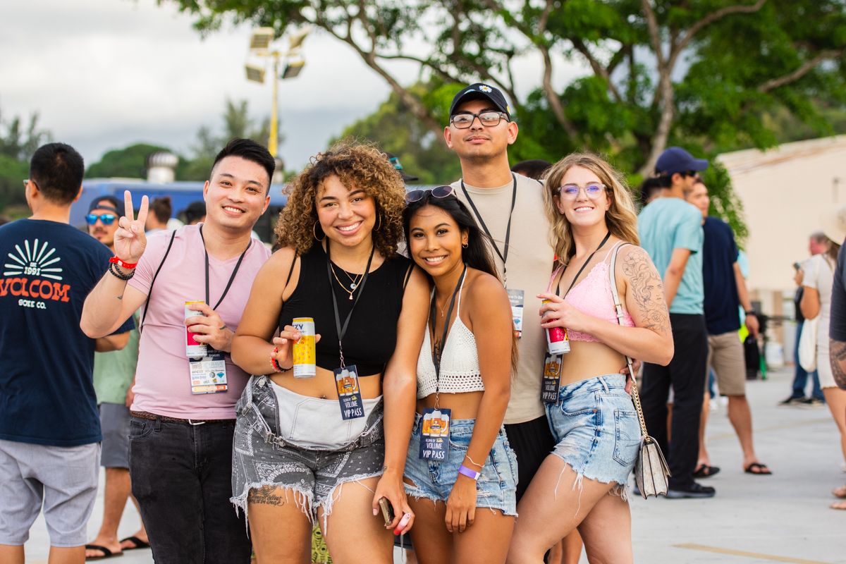 Group of friends enjoying a festival atmosphere outdoors.