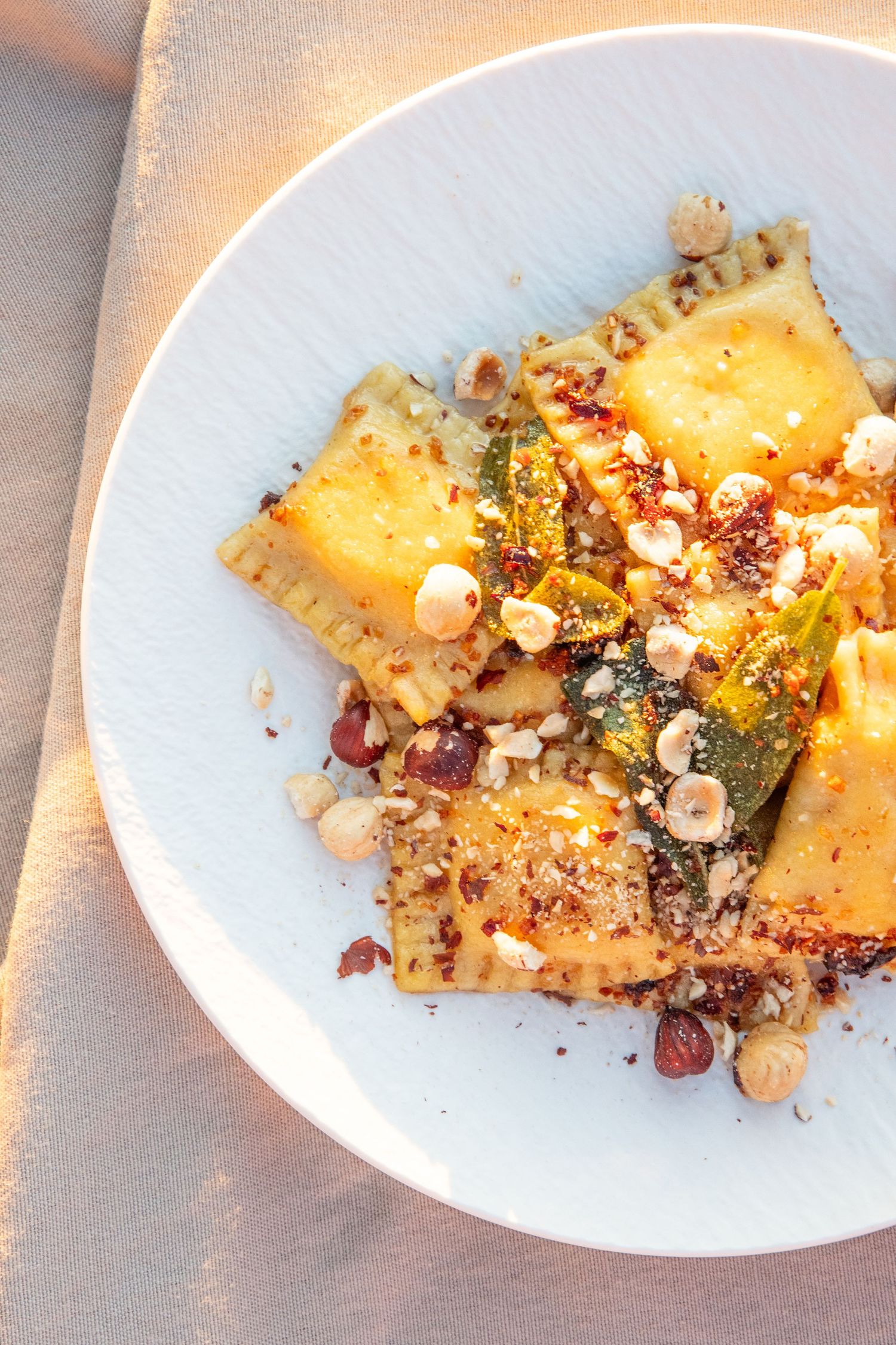 Detailed view of a dessert with nuts and garnishes served on a pristine white plate.