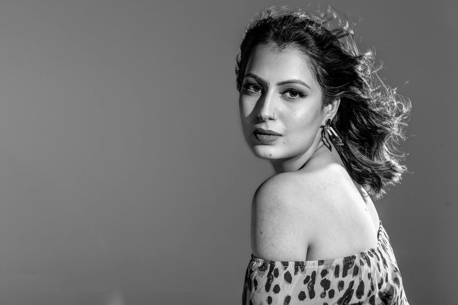 Black and white glamour portraits with flowing hair and dramatic poses.