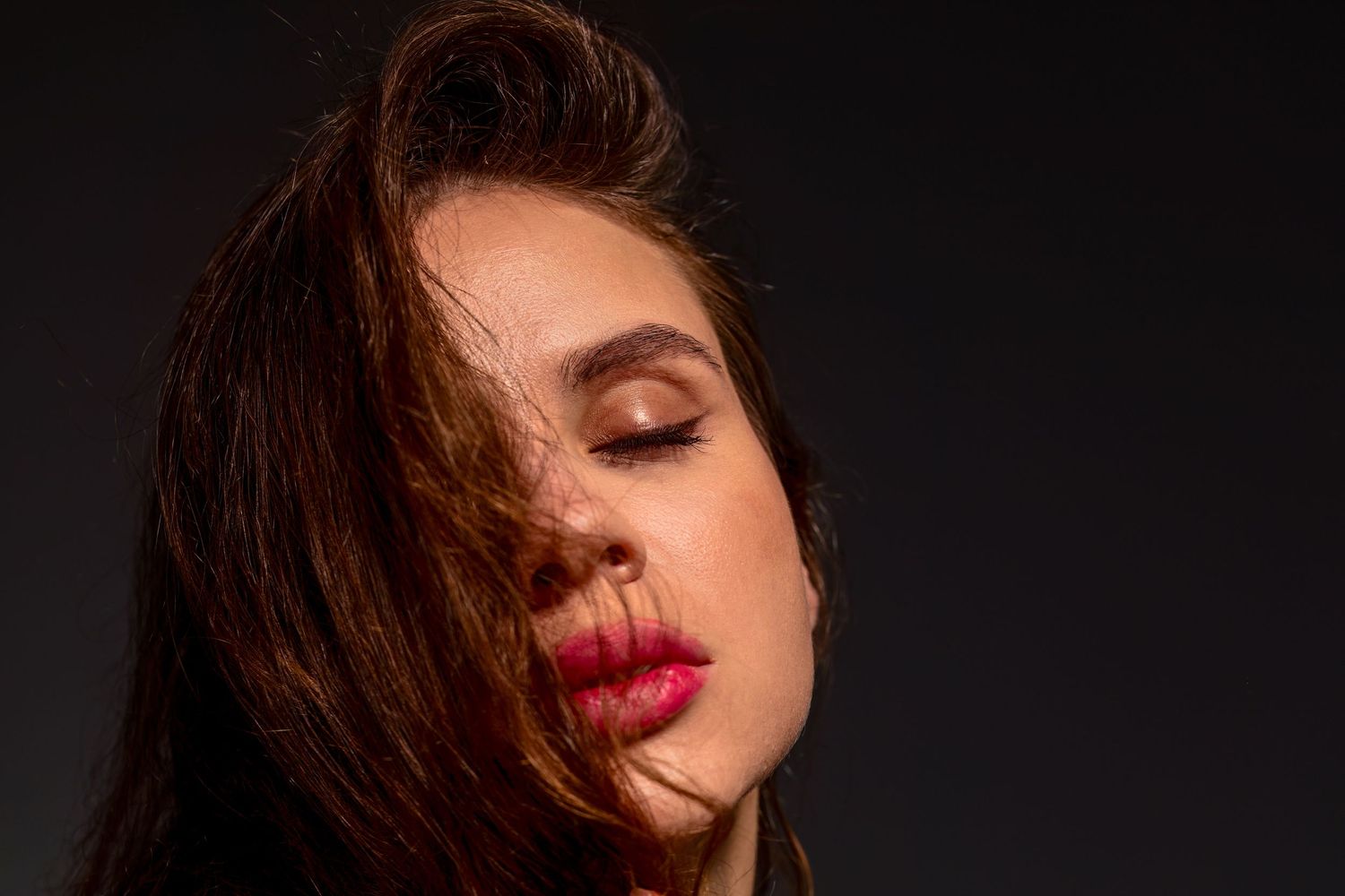 Artistic beauty portrait series showing close-up shots of red lips and brown hair against dark background.