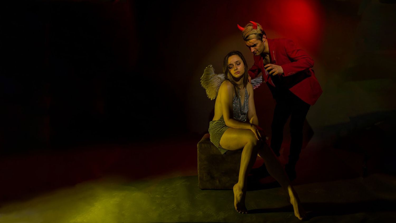 Theatrical performance with dramatic red and yellow lighting effects.