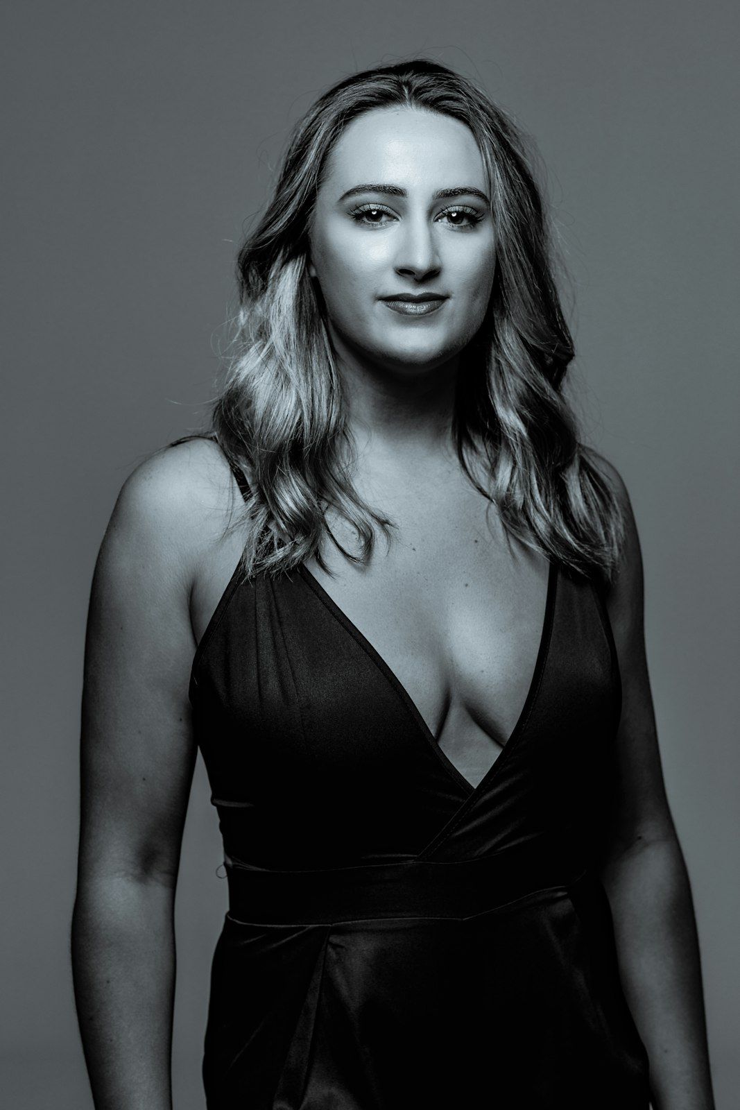 Black and white portrait series featuring elegant poses in dark attire.