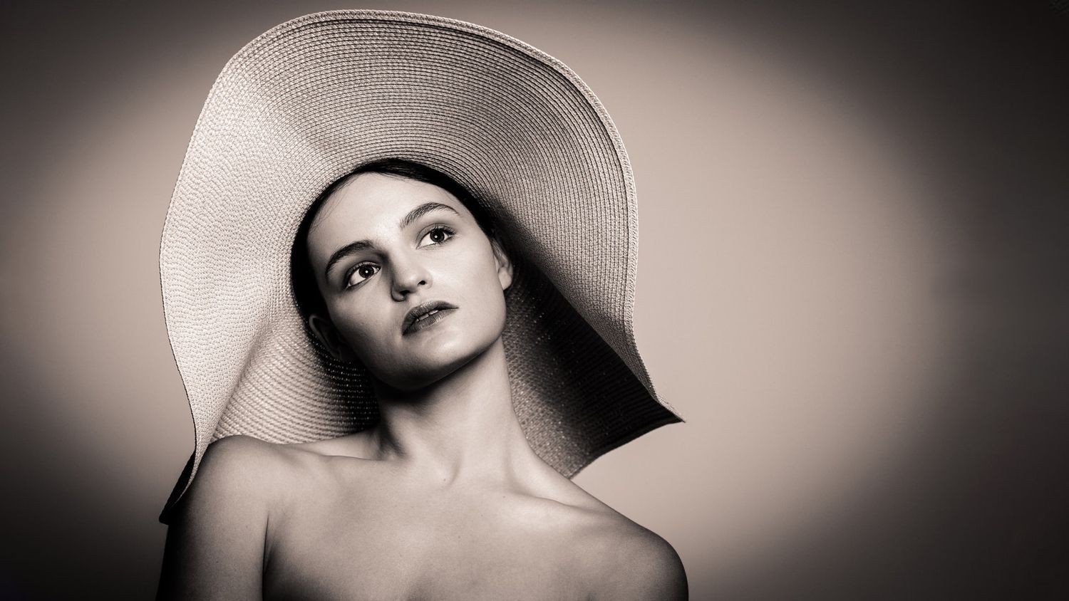 Artistic black and white portraits showing dramatic shadows and lighting effects.