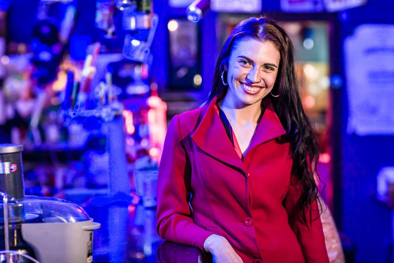Bar scene photography with dramatic blue and purple lighting effects.