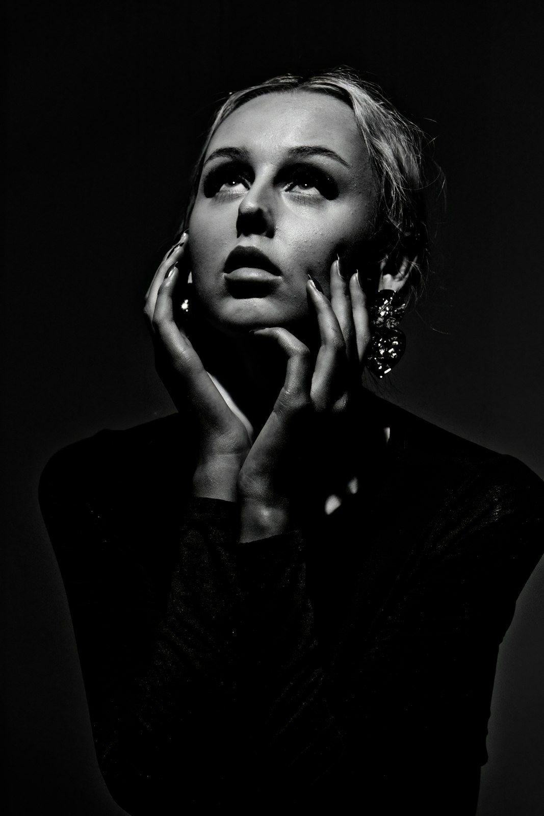 Dramatic black and white portraits with moody lighting and expressive poses.