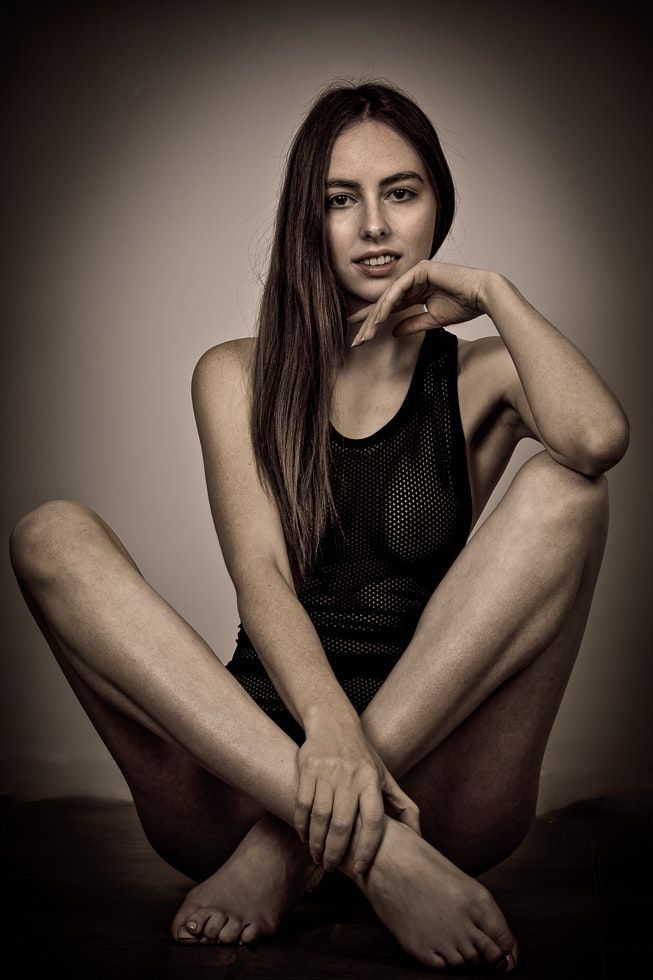 Minimalist black and white portrait series with dark vignette effect.