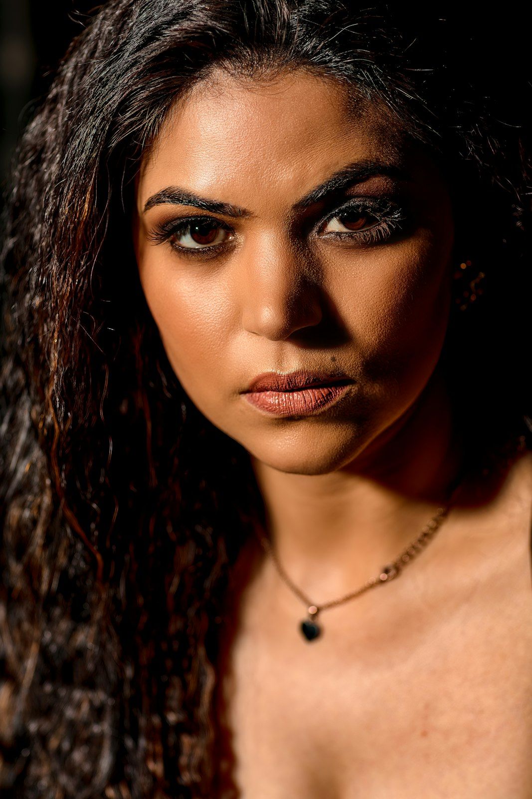 Close-up portrait series with dramatic shadows and jewelry details.