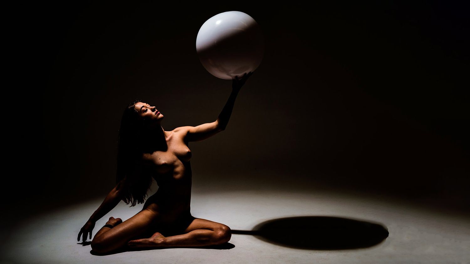 A dramatic sequence of dance movements captured in moody lighting against a dark background.