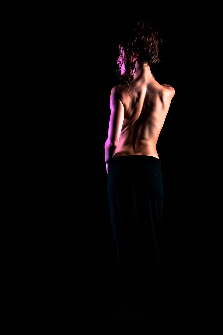 Artistic black and white photo series showing silhouetted figure in dramatic poses against dark background with purple lighting.