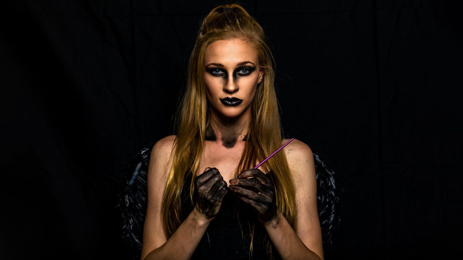 Dramatic portrait series with dark background and moody lighting.