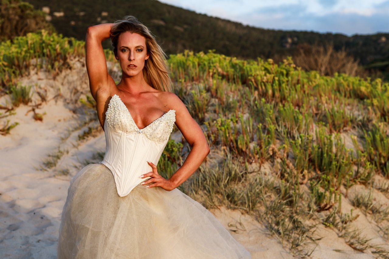 Beachside fashion photography with natural coastal vegetation.