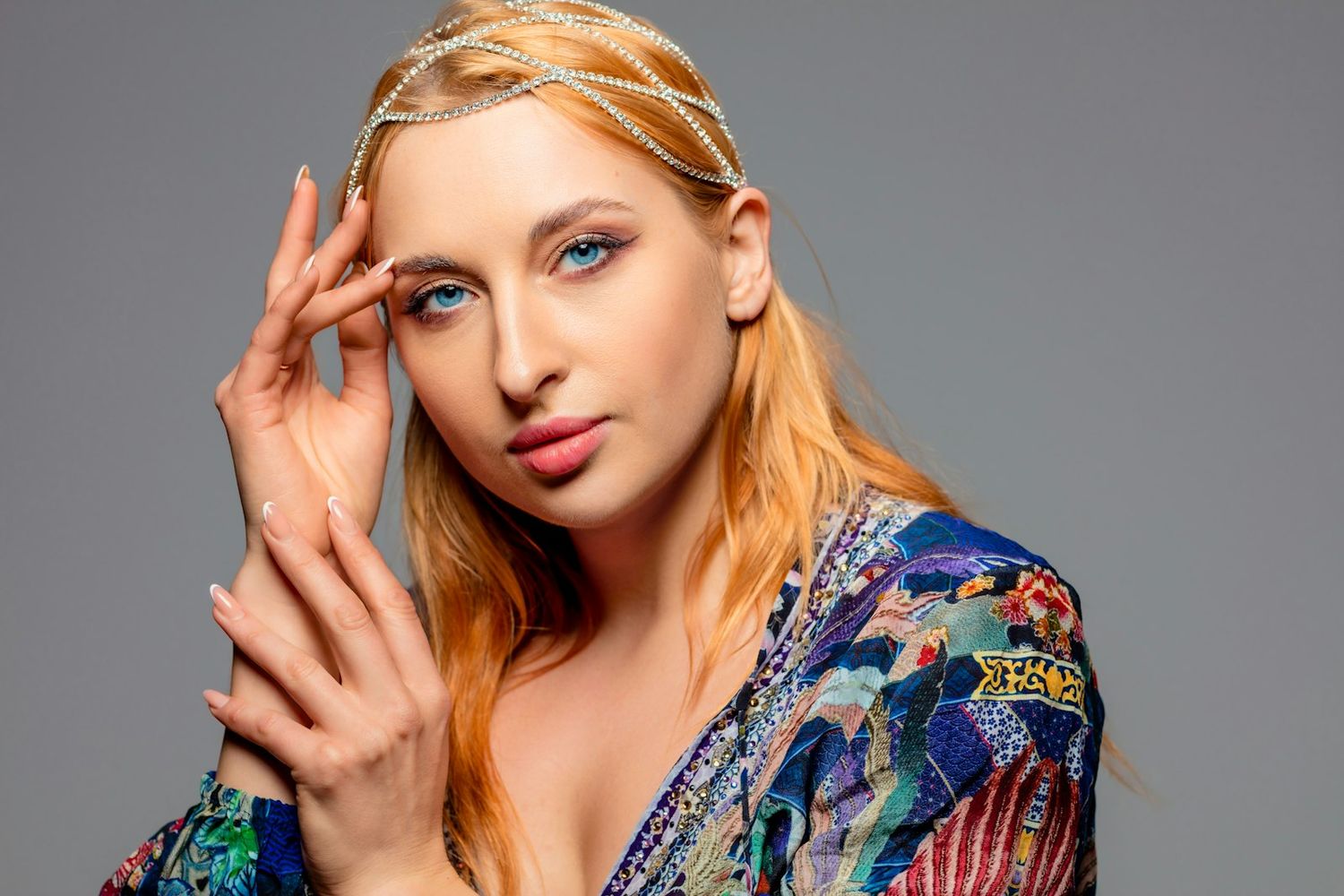 Studio fashion portraits with colorful patterned clothing against grey background.