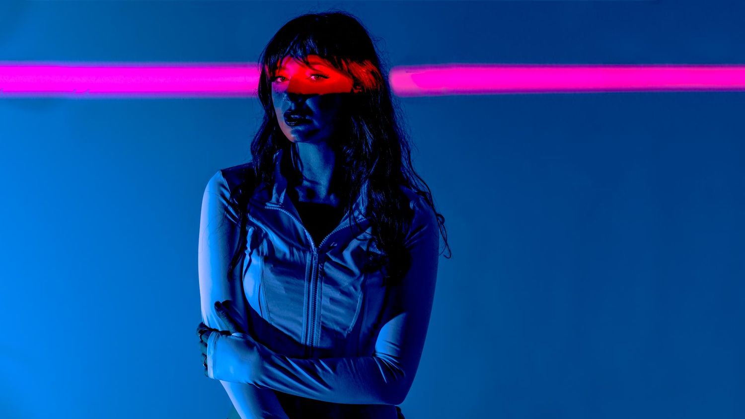 Dramatic performance with pink and blue lighting effects on stage.