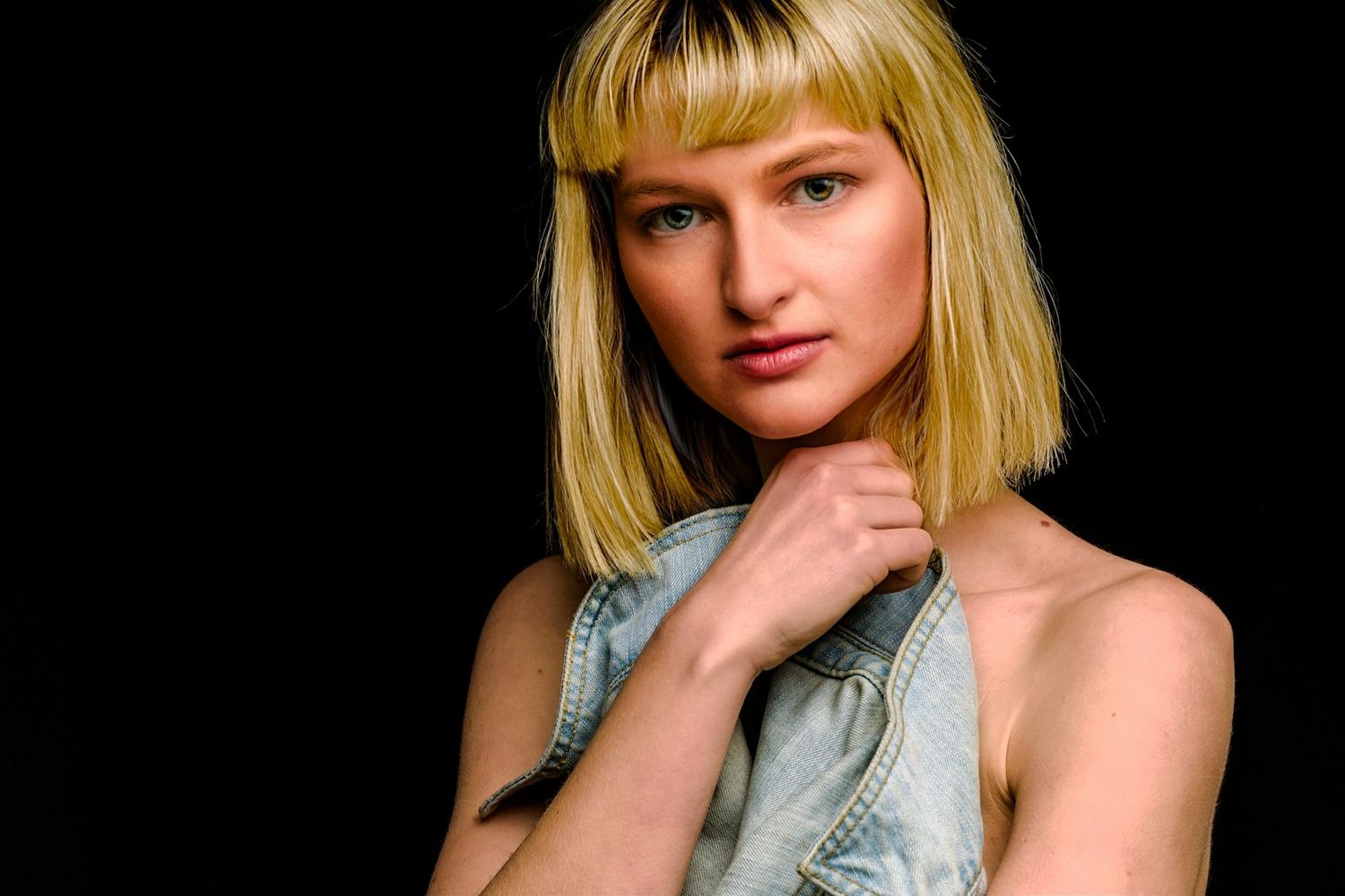 Artistic portrait series with dramatic lighting against dark background.