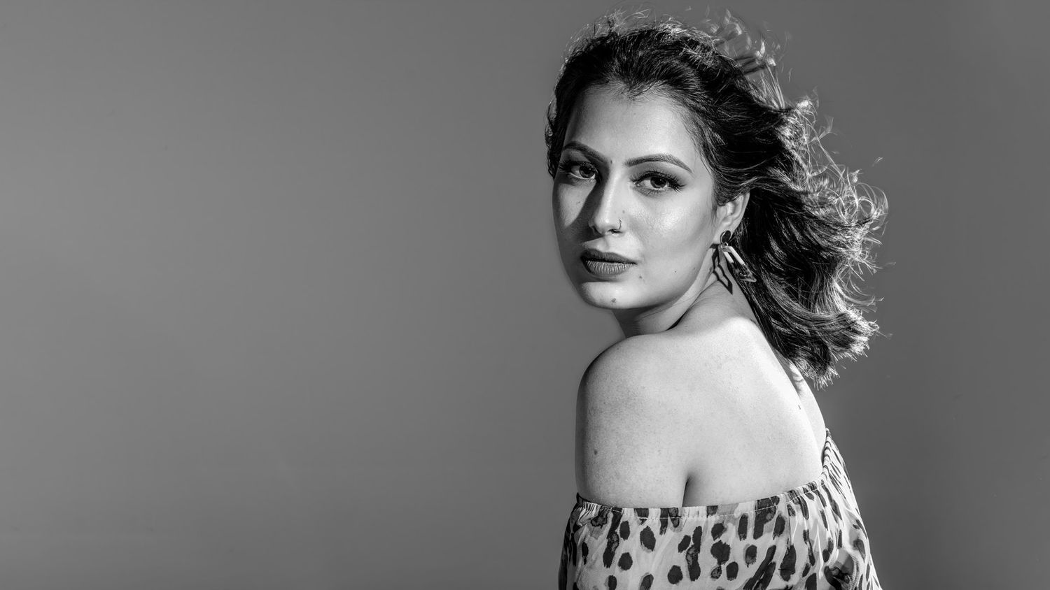 Series of black and white studio portraits with dramatic lighting.