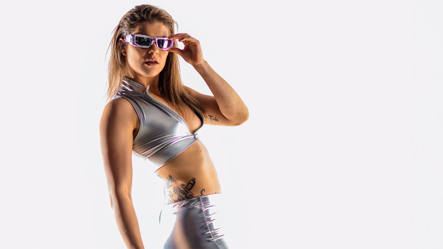 Athletic figure poses in workout attire against white background.