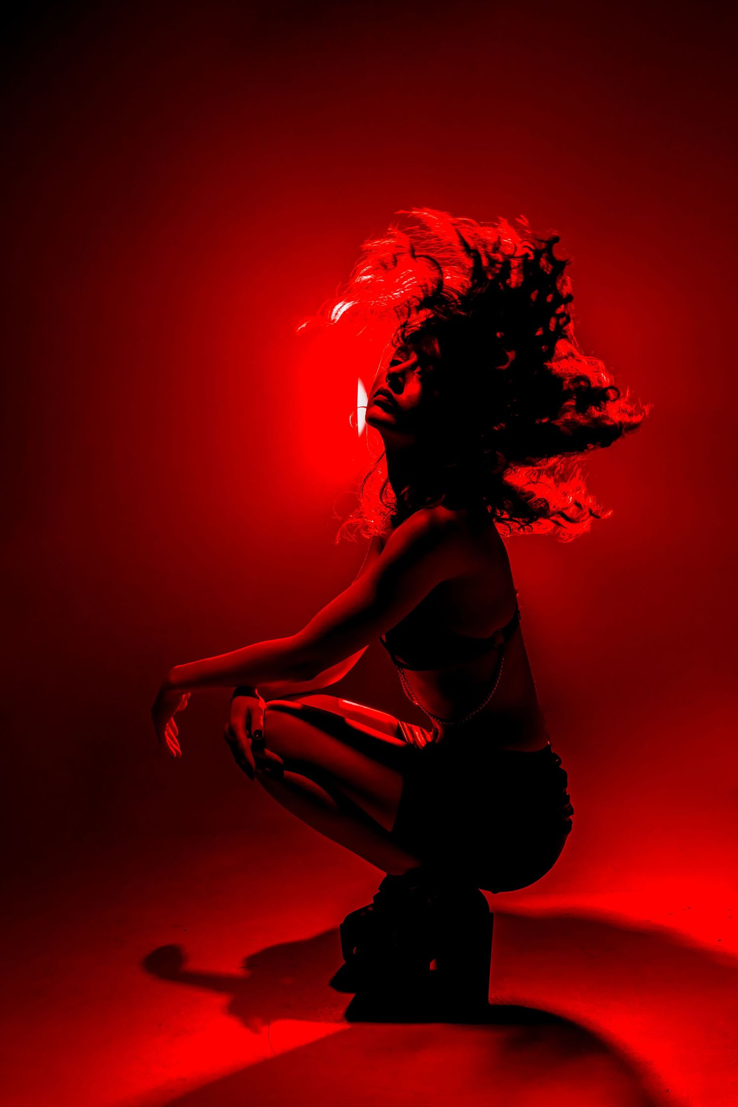 Artistic dance photography sequence showing fluid motion against deep red background.