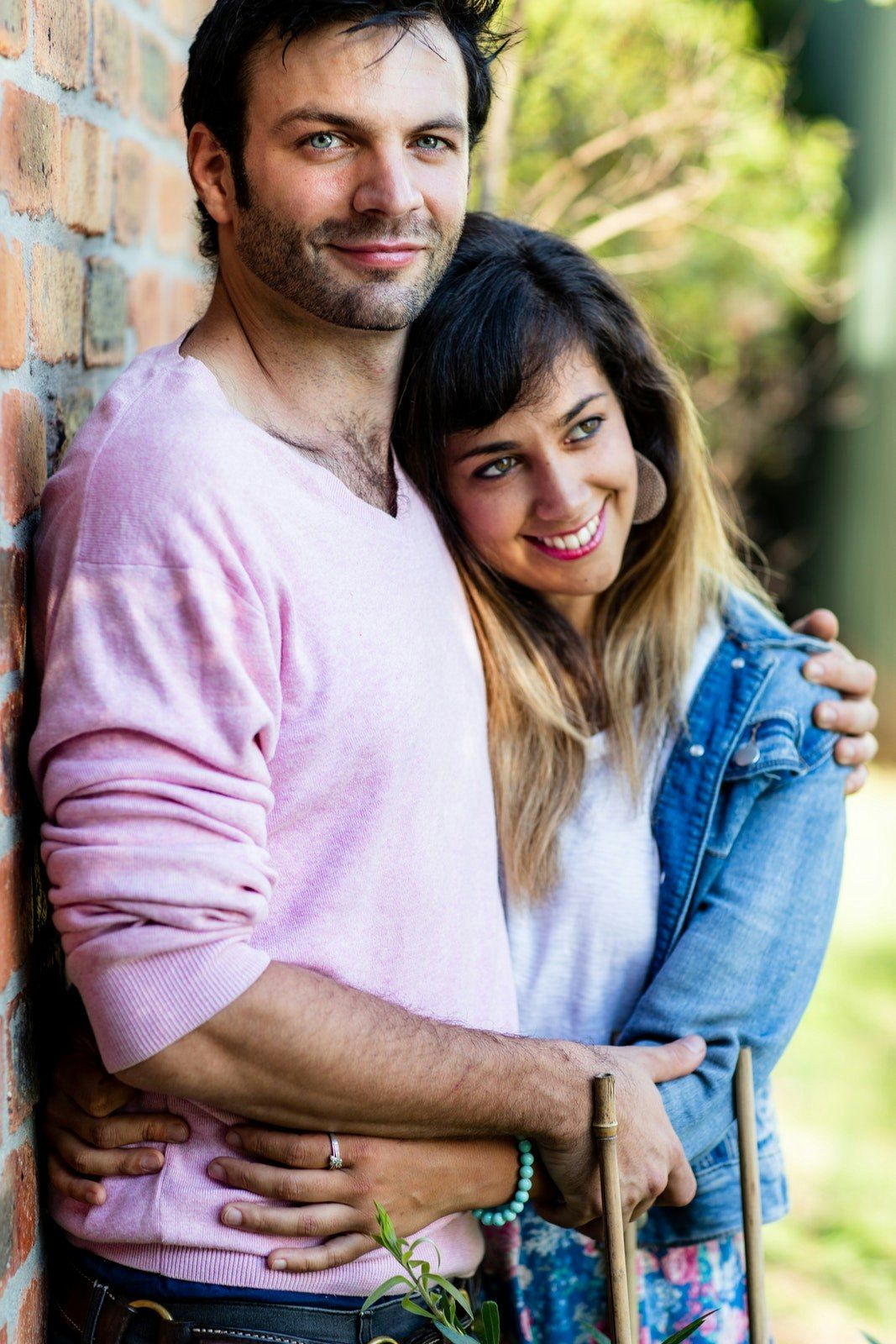 Candid outdoor couple photos showing affectionate embraces.