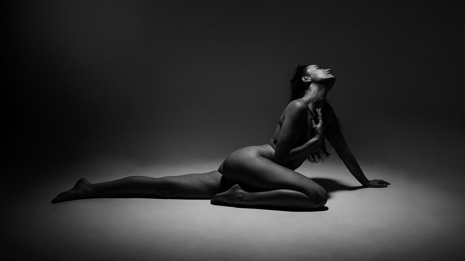 A black and white artistic photo series showing a ballet dancer performing graceful poses in dramatic lighting.