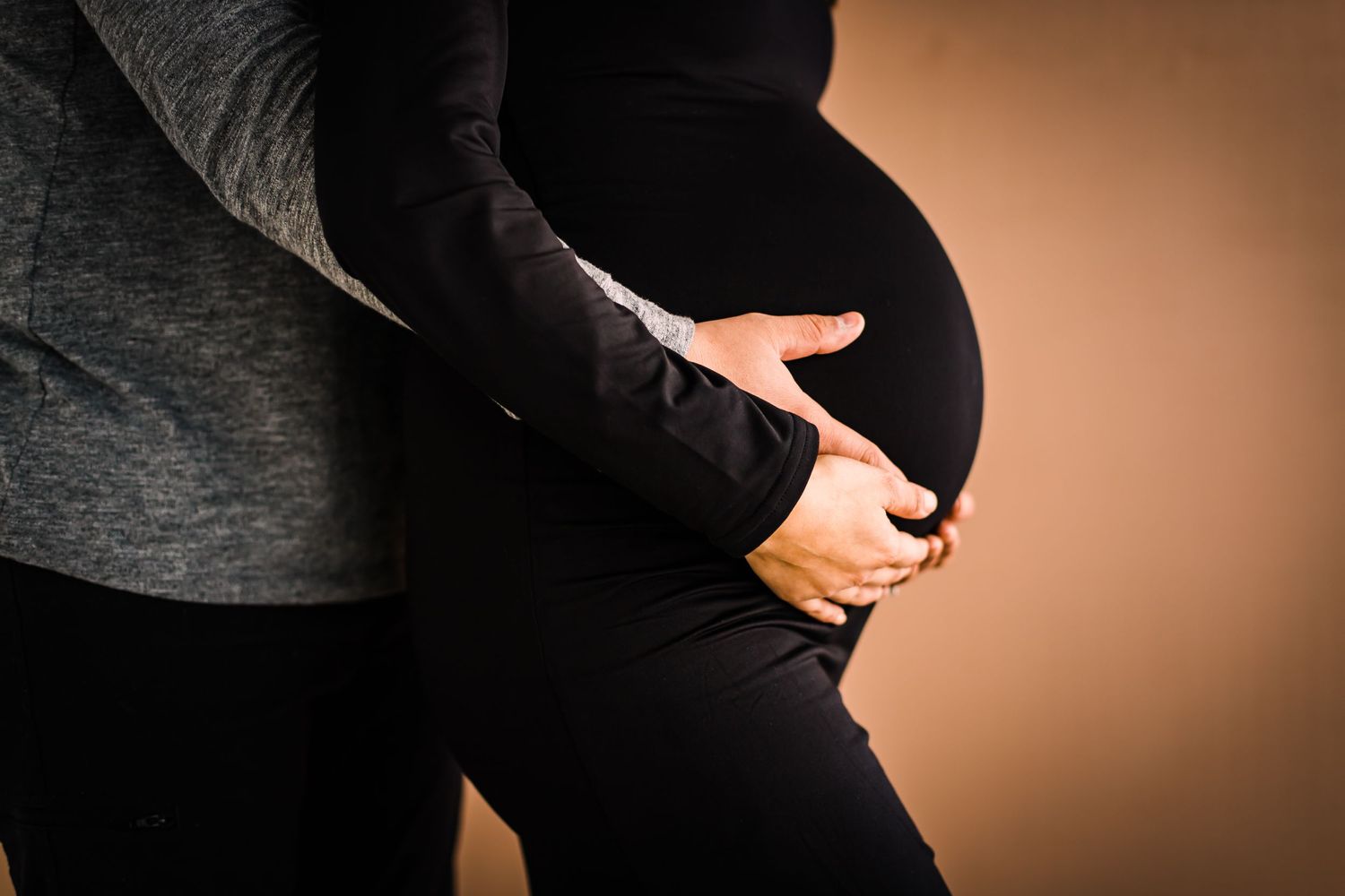 studio maternity photoshoot mom in black dress