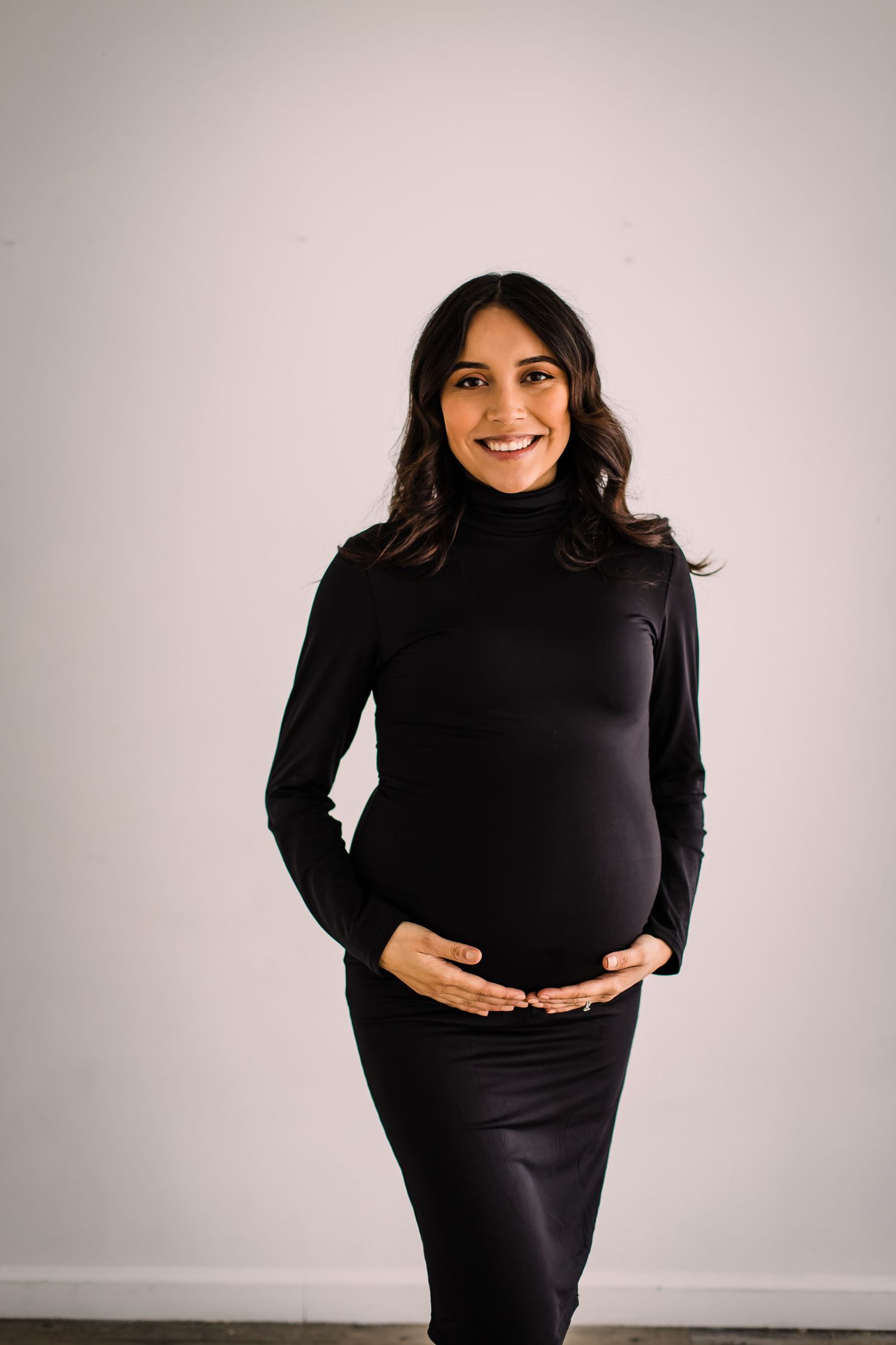 studio maternity photoshoot mom in black dress