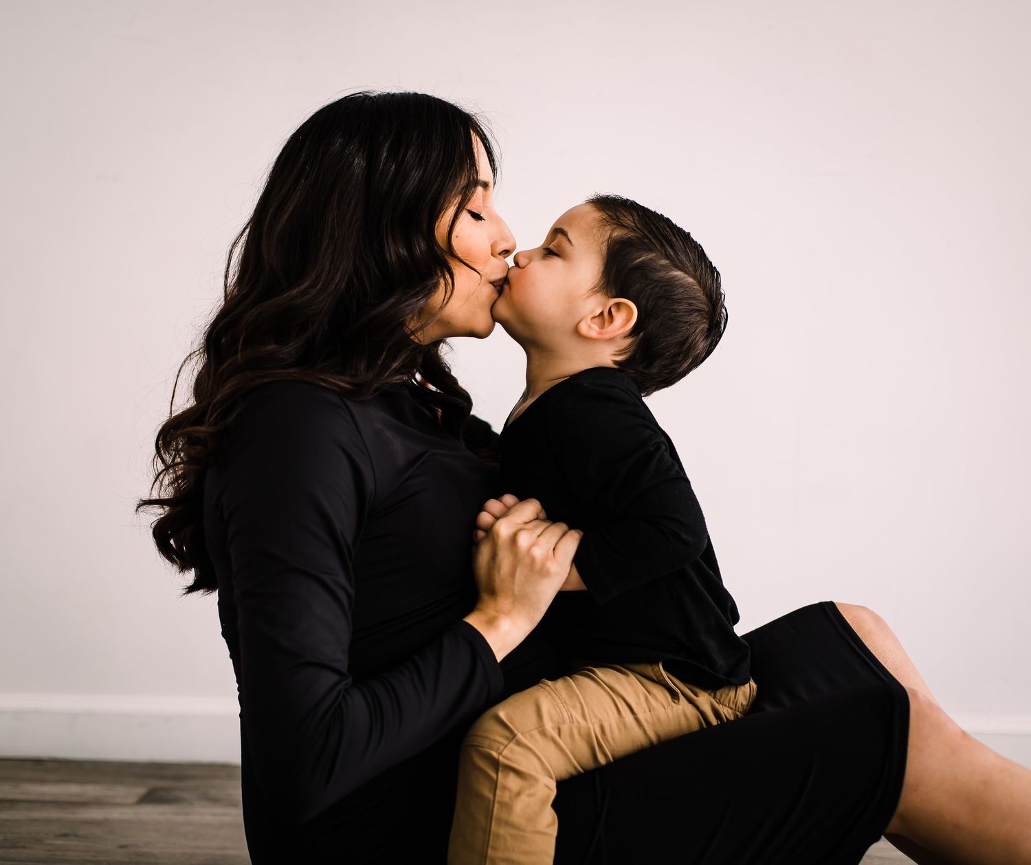 child kissing mom studio maternity photos