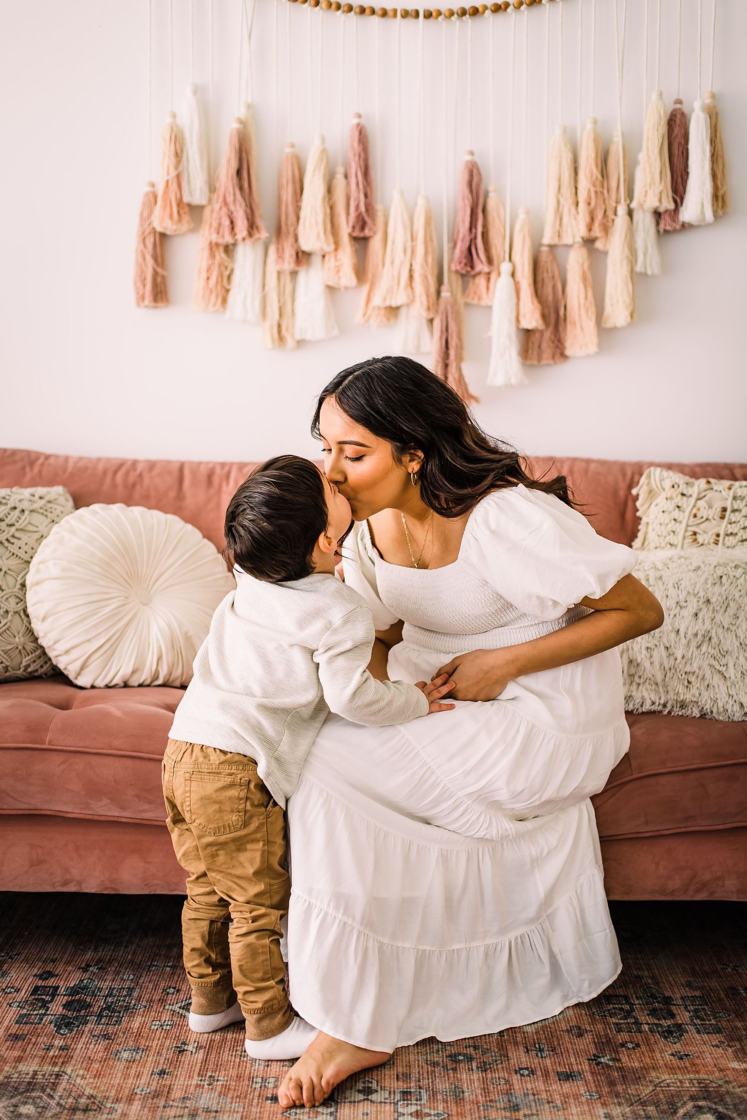 child kissing mom maternity photoshoot
