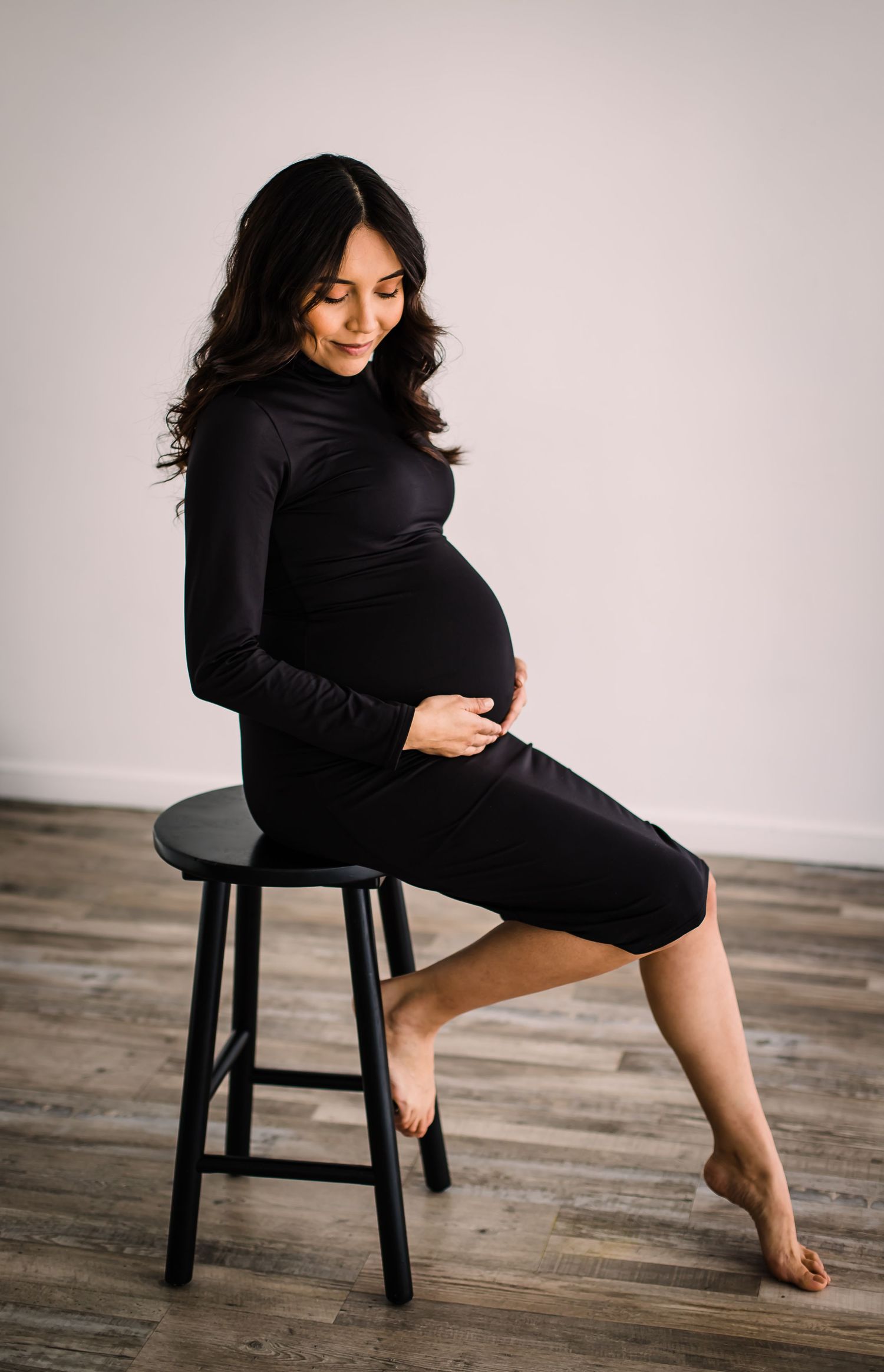 studio maternity photoshoot mom in black dress
