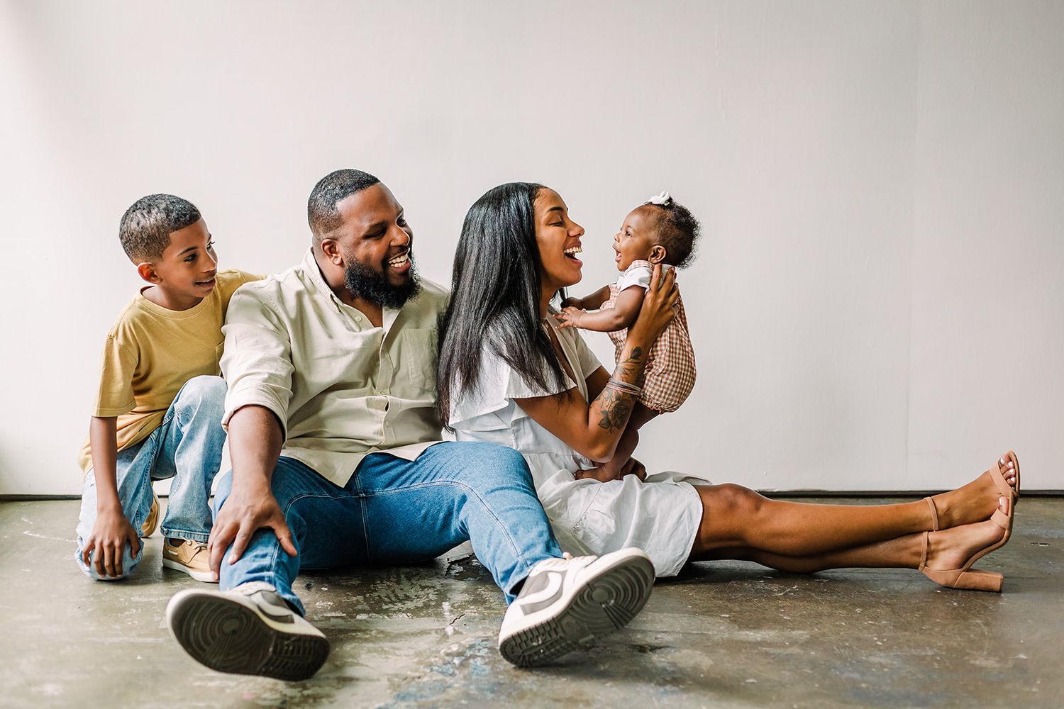 Family members lying on floor at home spending quality time together and playing in casual comfortable setting.