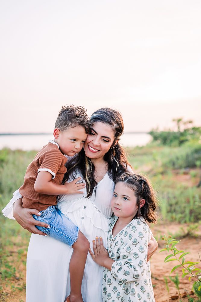 Intimate family portrait series captured in warm sunset light against natural backdrop.