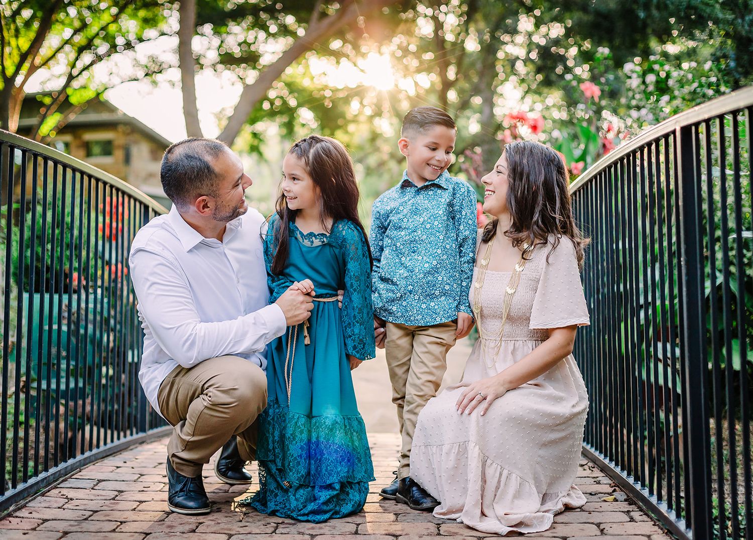 Group portrait session on a bridge with people wearing coordinated blue and white outfits.