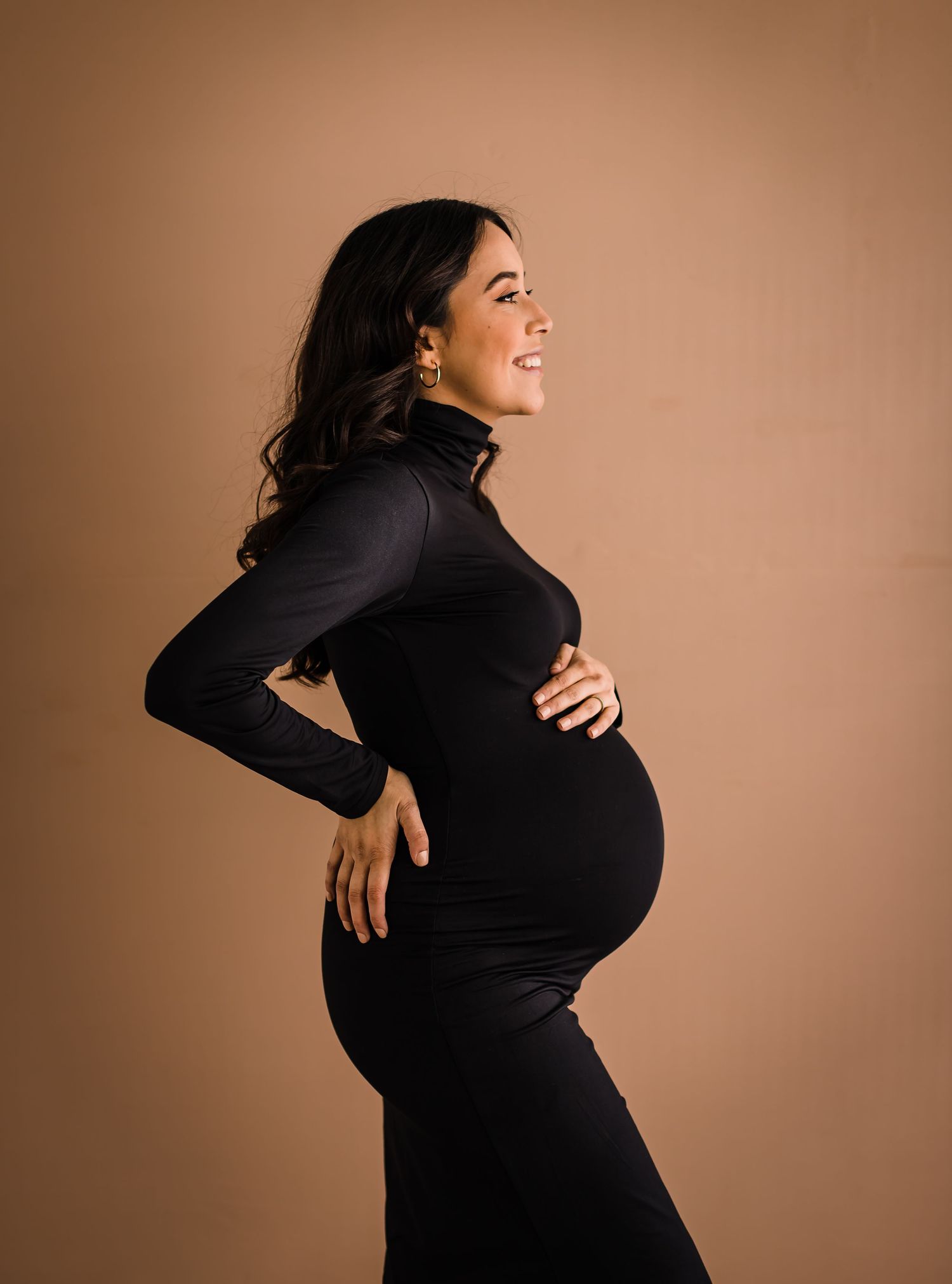 studio maternity photoshoot mom in black dress