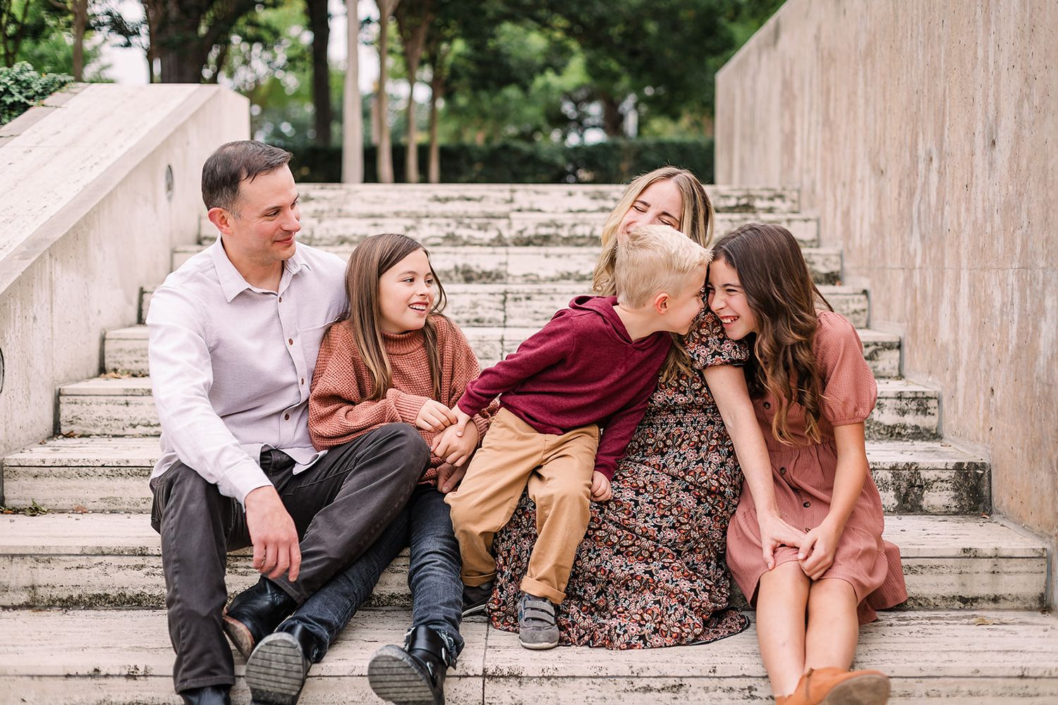 Series of casual family portraits taken on stone steps with natural lighting.