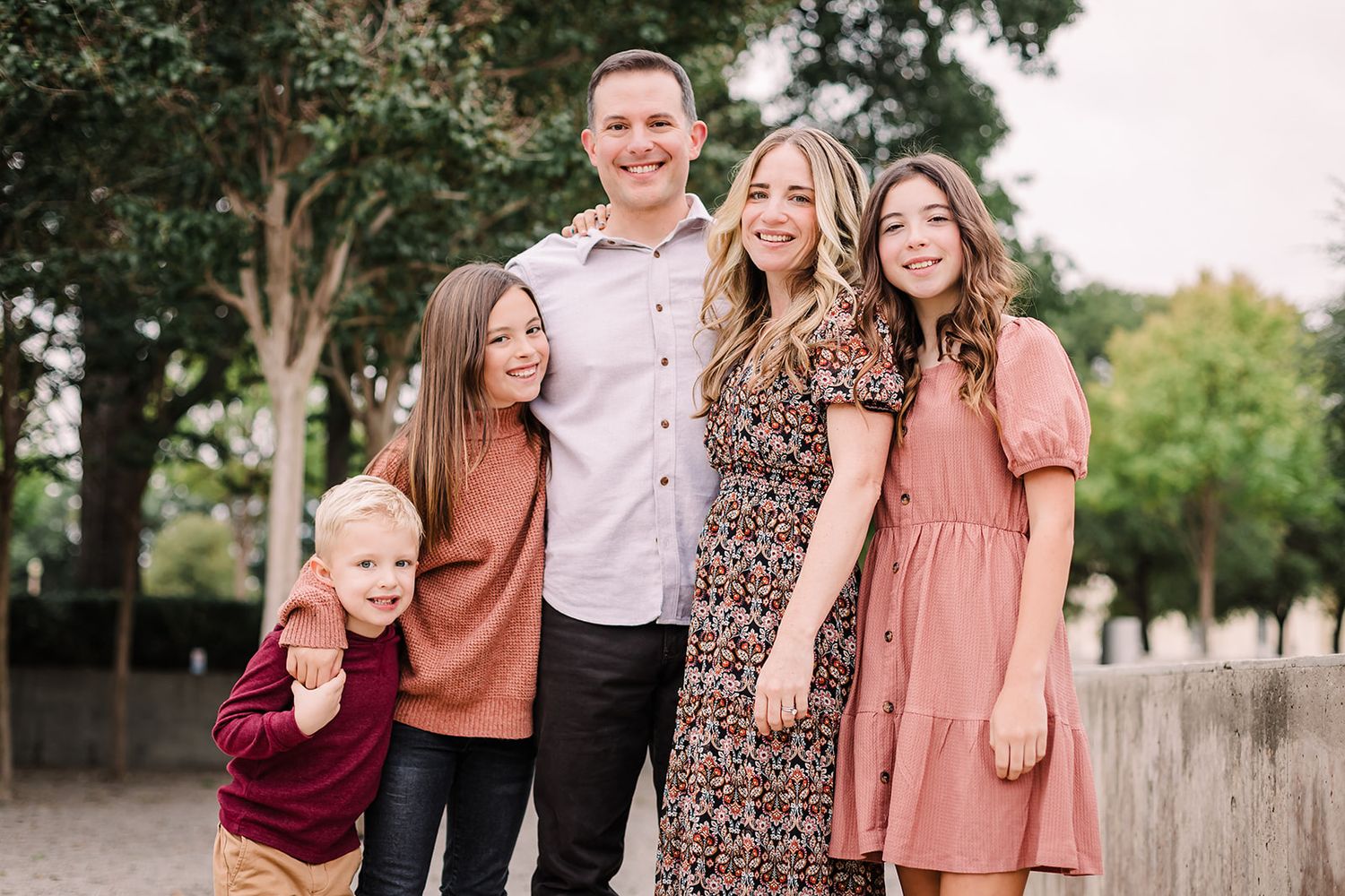 Casual outdoor family portraits with people wearing fall-colored clothing against natural backgrounds.