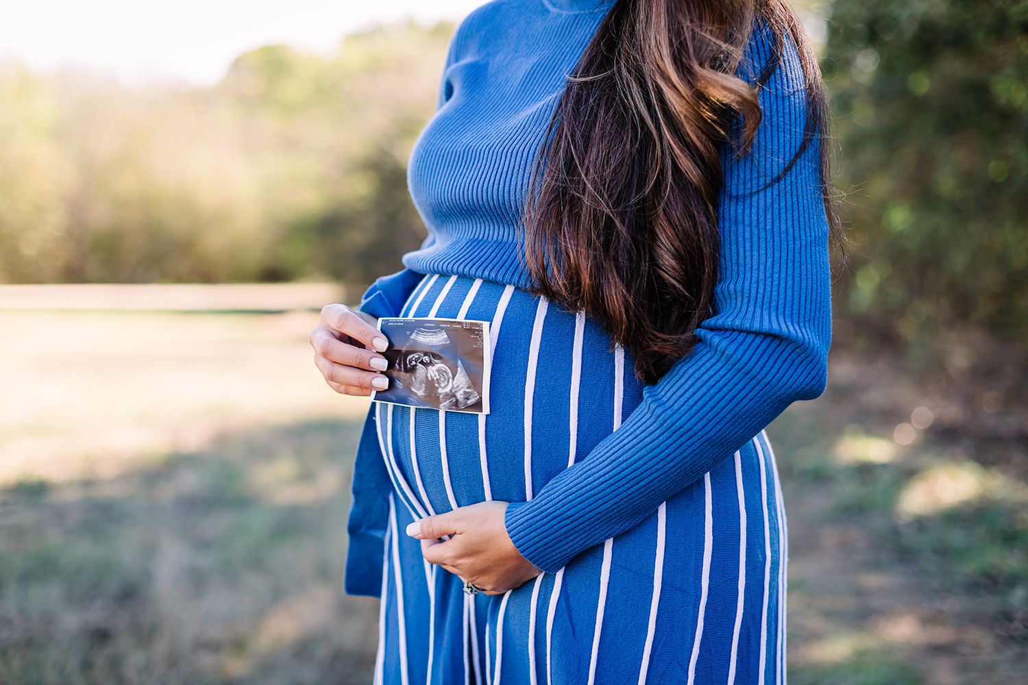 Series of maternity photos showing a pregnant woman in a blue striped dress against a natural backdrop.