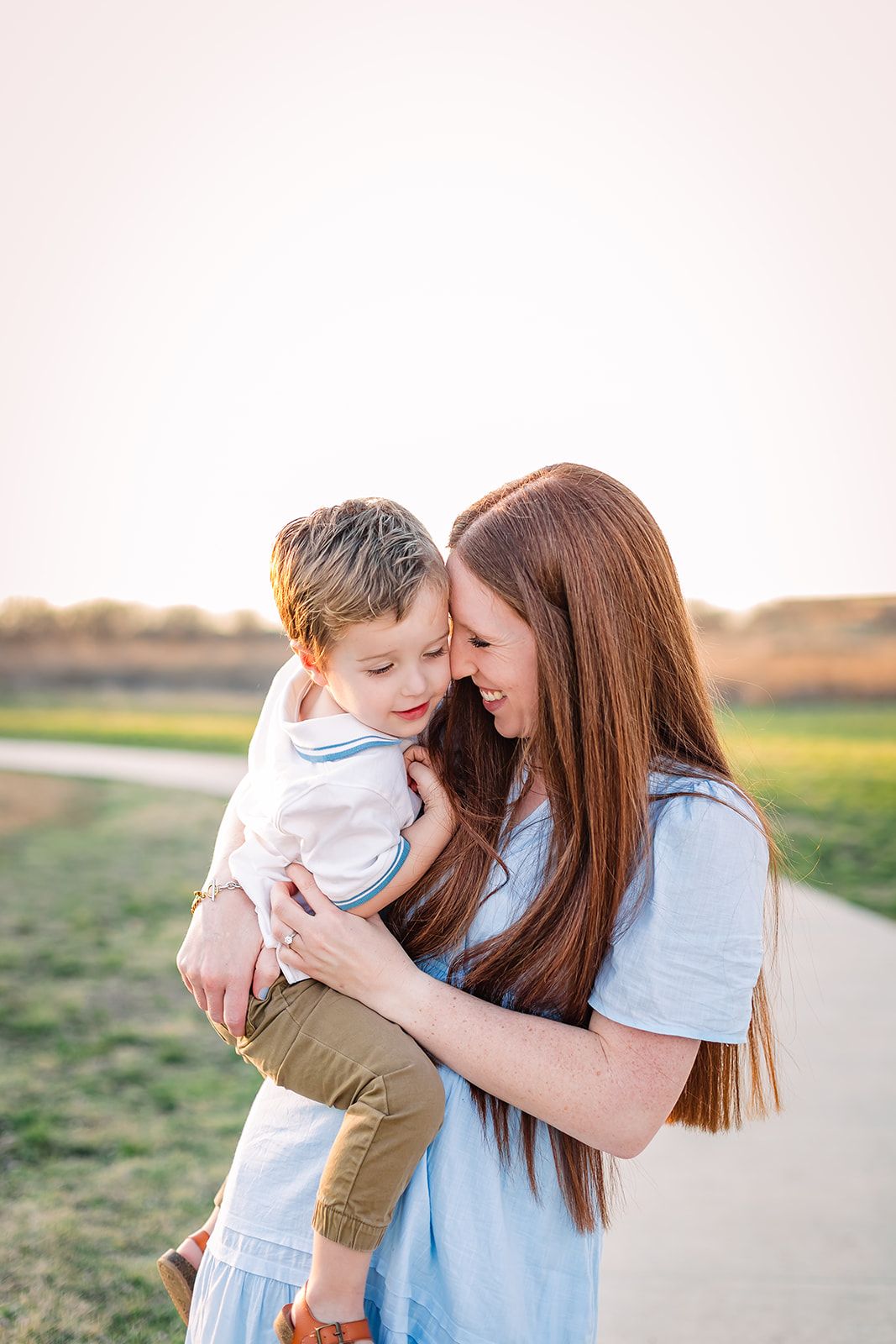 Tender family moments captured during sunset outdoor photo session.
