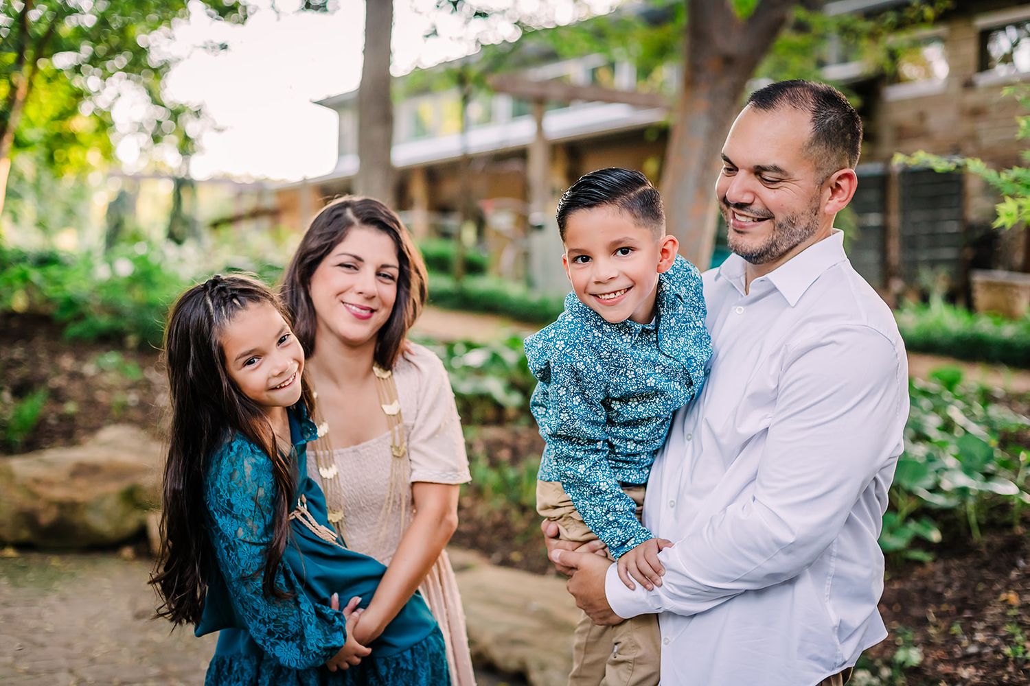 Candid family moments captured in a series of outdoor photos with natural greenery.