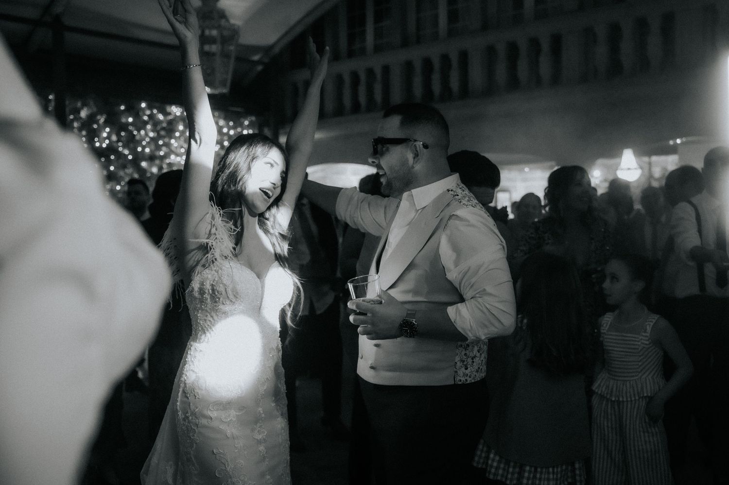 A series of black and white photographs showing people dancing at what appears to be a wedding reception or celebration.