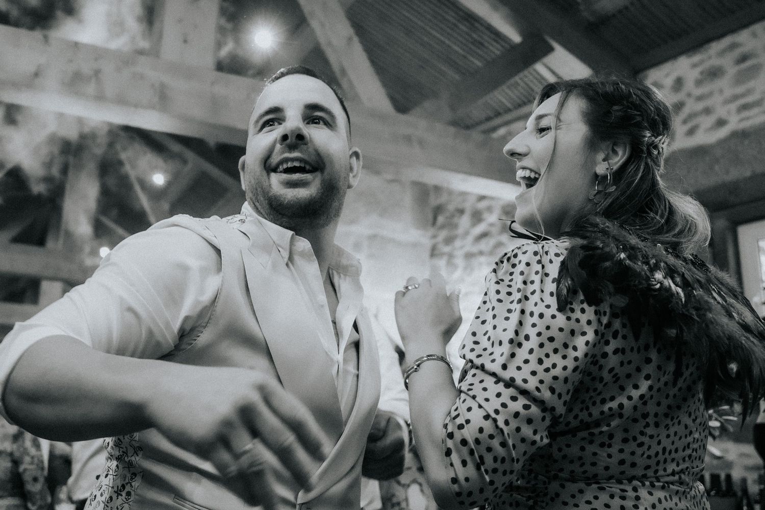 People dancing and laughing together at a lively social gathering or celebration event.