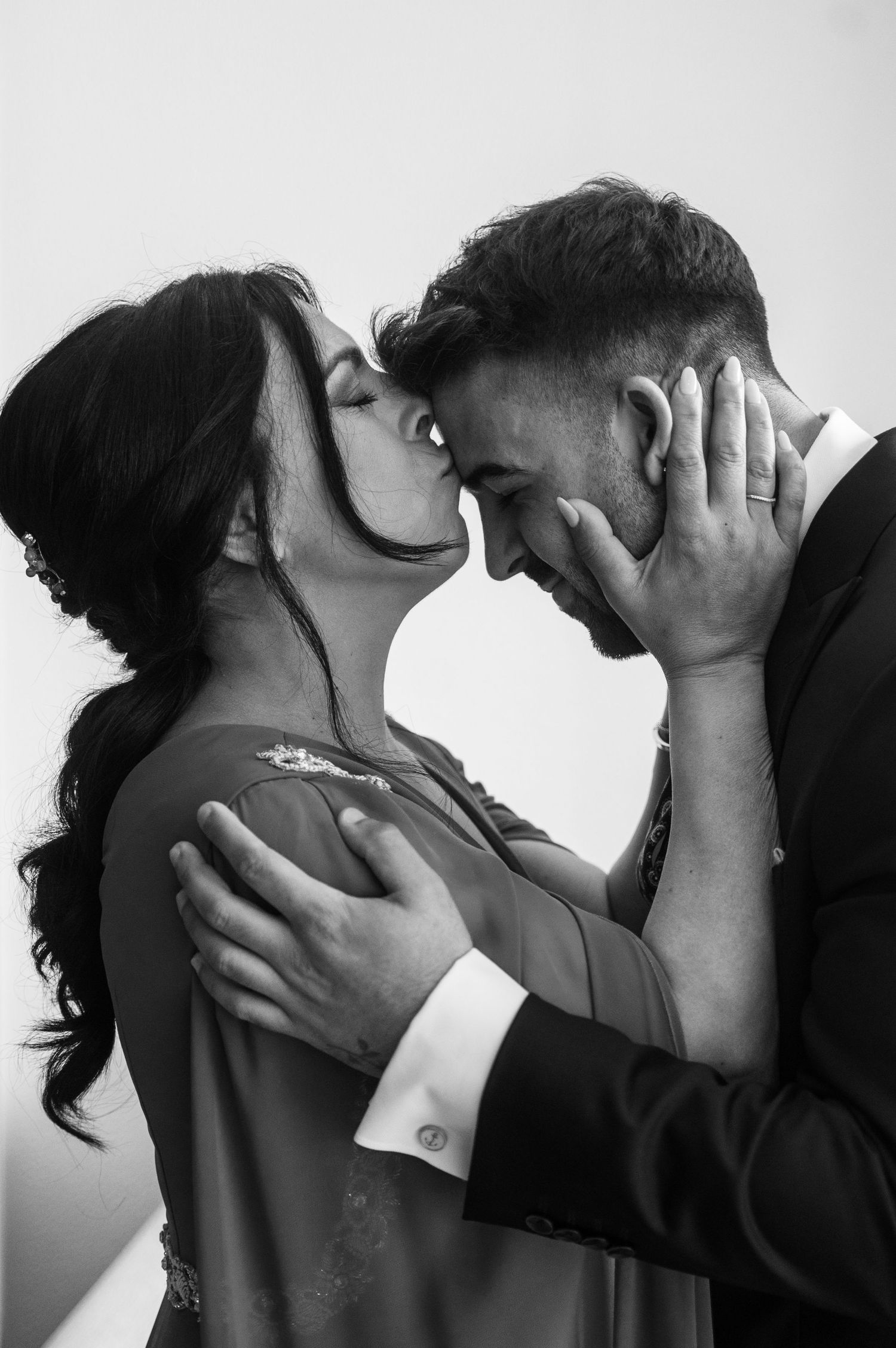 A black and white photo sequence showing a romantic kiss between two people in a cinematic style.